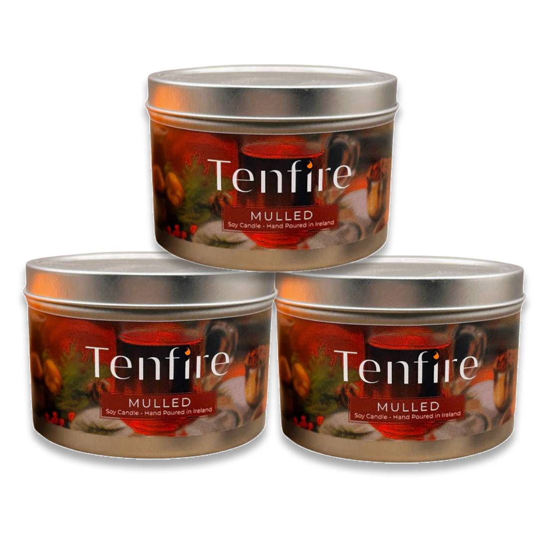 Three Tenfire Mulled candle tins stacked on a white background