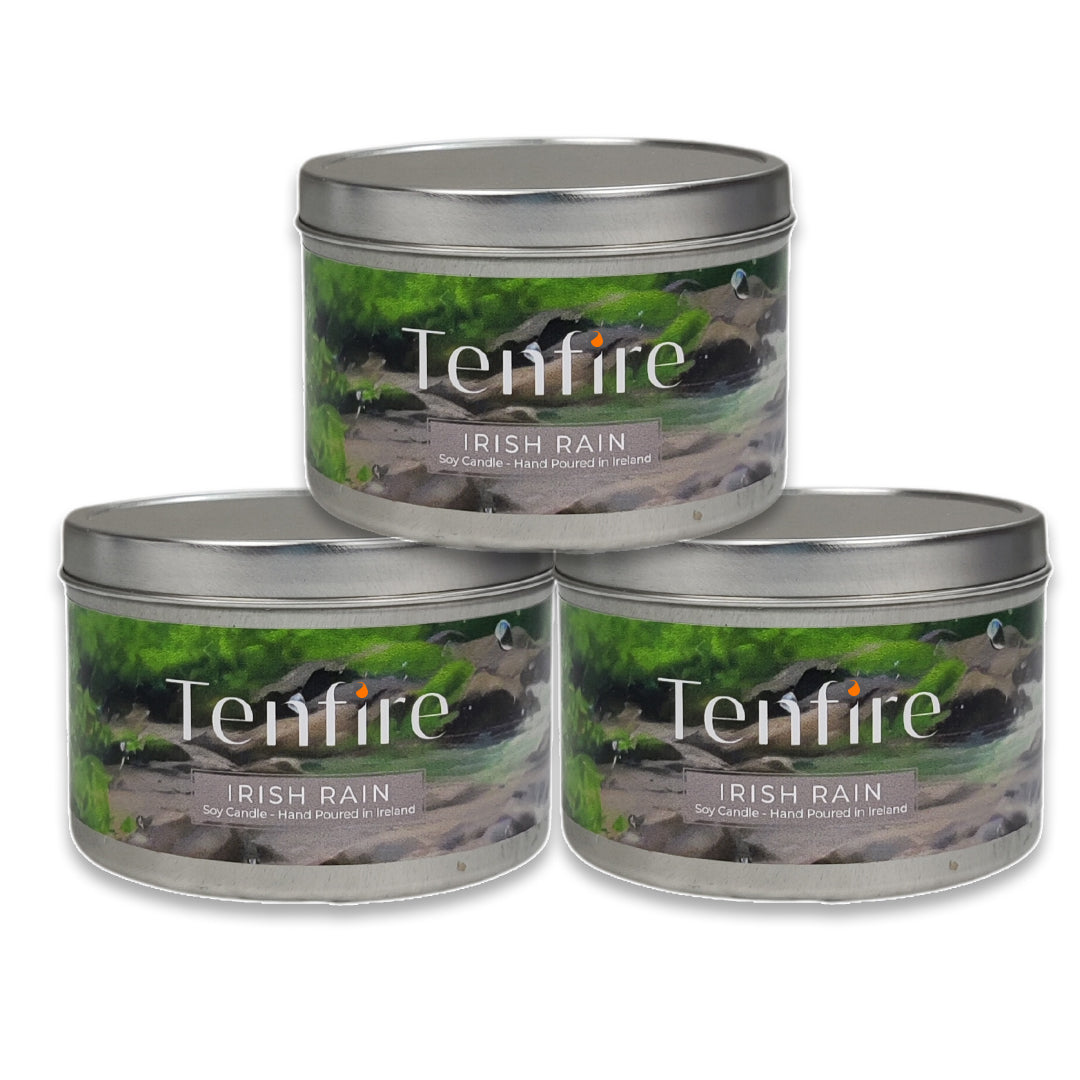 Three Tenfire Irish Rain candles in metal tins on a white background