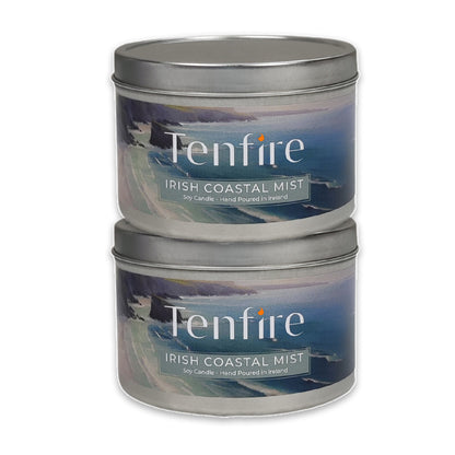Two Tenfire Irish Coastal Mist candles in metal tins on a white background
