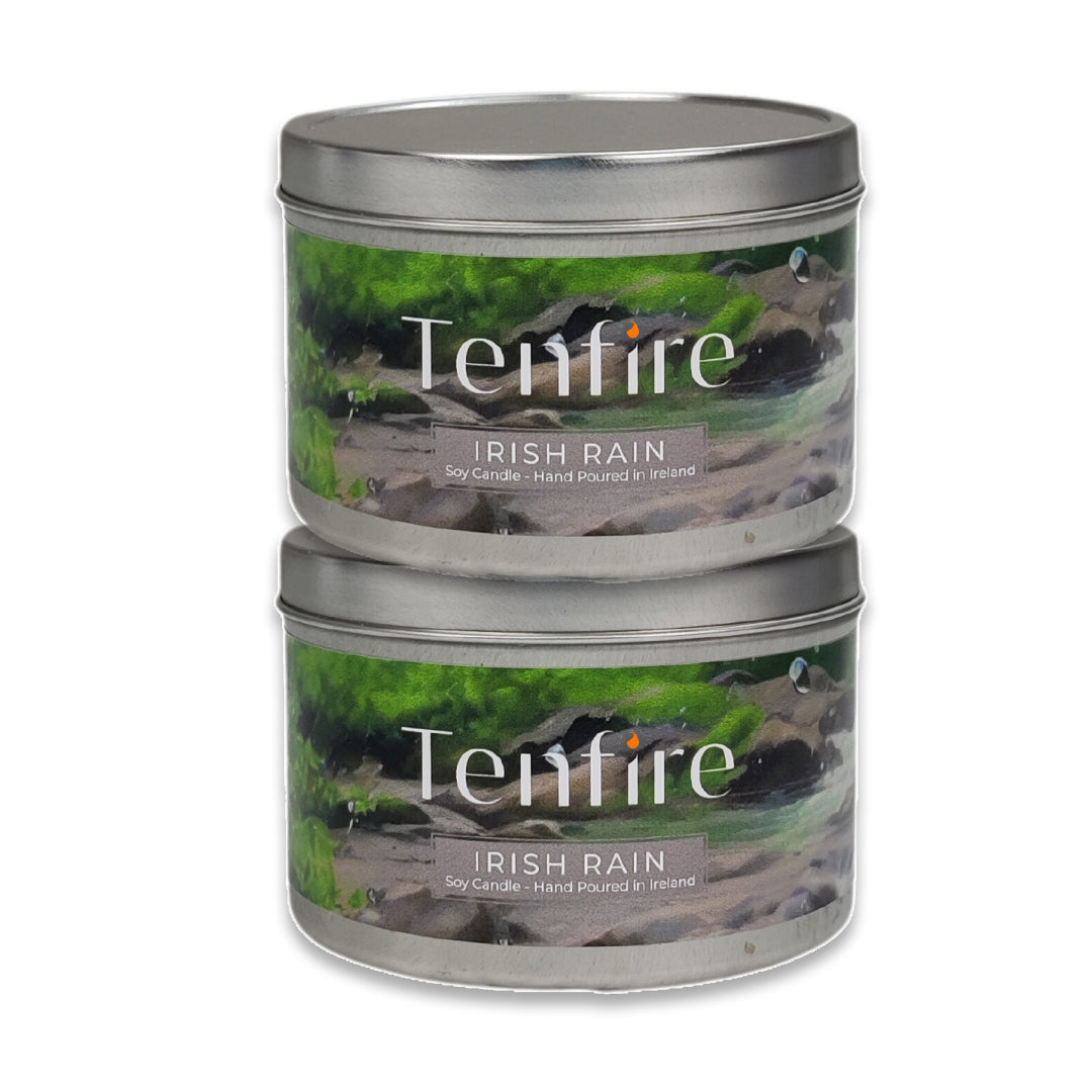 Two Tenfire Irish Rain candles in metal tins on a white background