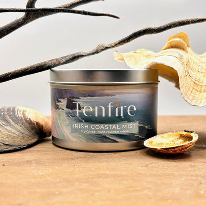 Tenfire Irish Coastal Mist candle in a tin on a wooden surface with natural elements.