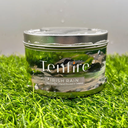 Tenfire candle labeled 'Irish Rain' on a grassy surface