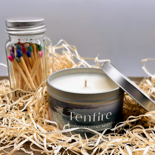 an open soy candle tin with a glass jar of matches behind both Tenfire branded