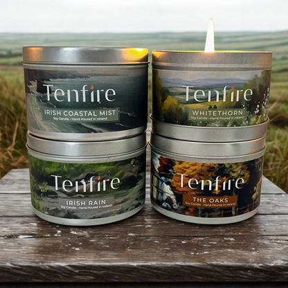 Collection of Tenfire candles with scenic labels on a wooden surface.
