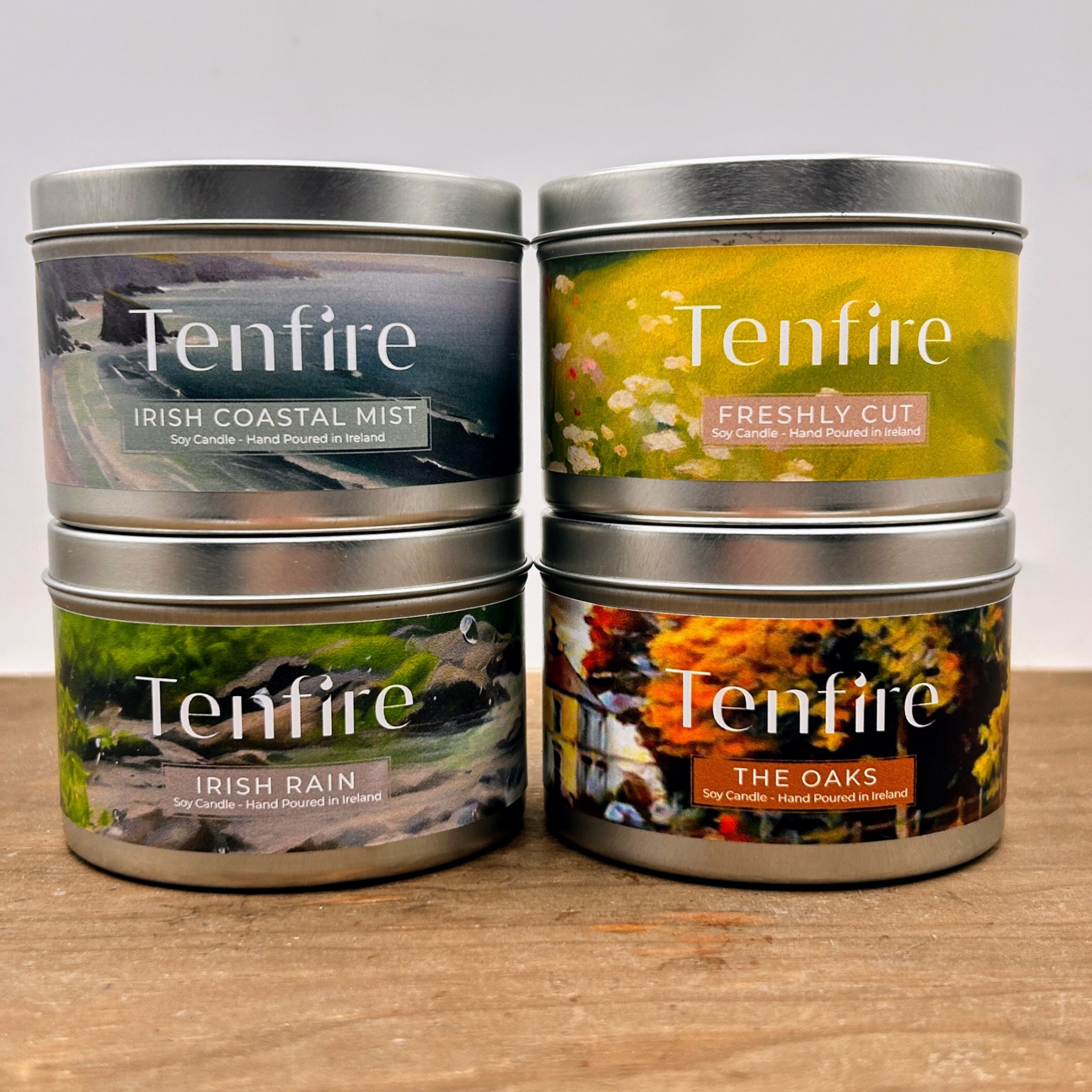 four different candle tins in two stacks of two next to each other